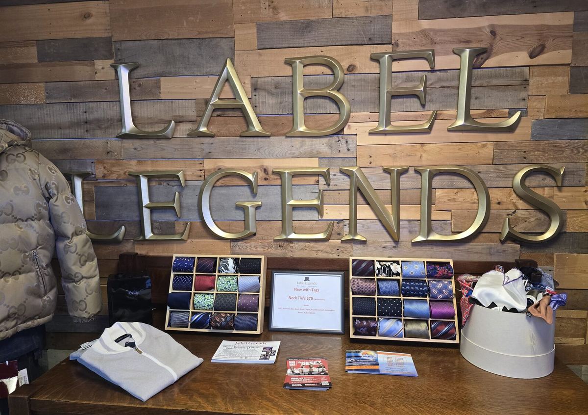 Inside the Label Legends showroom in Farmington Hills — the Label Legends wall with new-with-tags neckties
