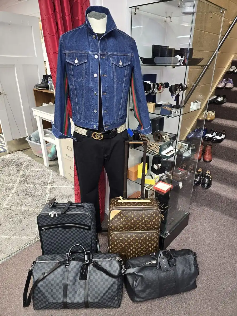 Inside the Label Legends showroom in Farmington Hills — designer denim jacket and Louis Vuitton luggage
