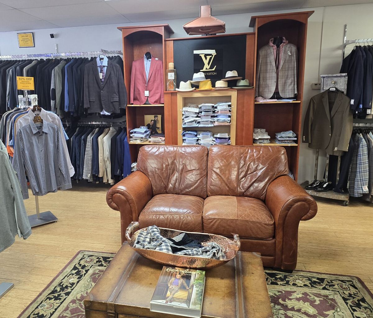 Inside the Label Legends showroom in Farmington Hills — dress shirt shelves and suiting racks