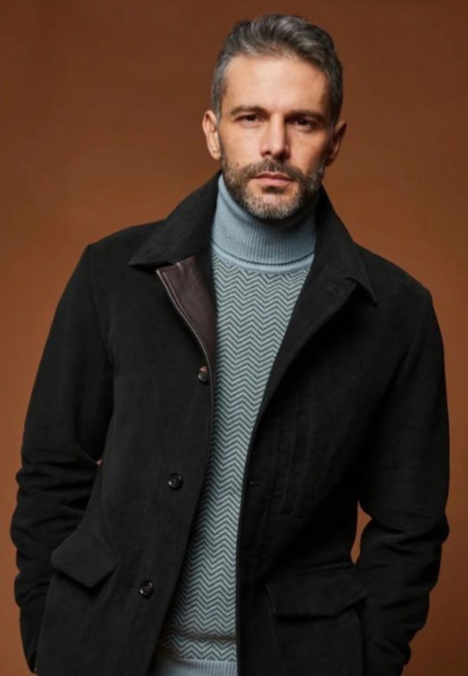Black wool car coat over a chevron knit and blue turtleneck