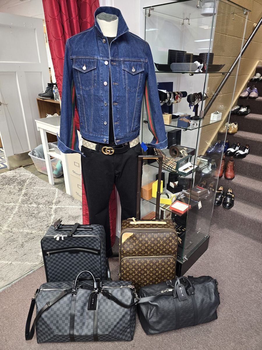 Inside the Label Legends showroom in Farmington Hills — designer denim jacket and Louis Vuitton luggage