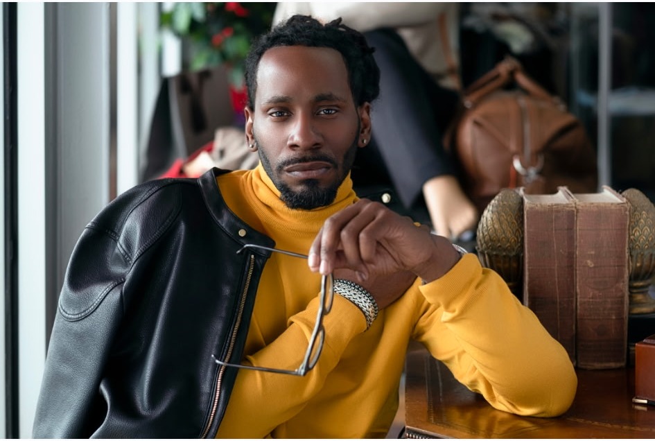 Black leather moto jacket over a gold turtleneck